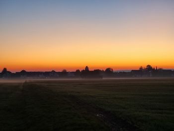 Scenic view of field against sky during sunset