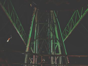 Low angle view of illuminated bridge against sky at night