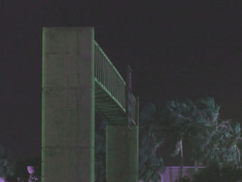 Low angle view of bridge against sky at night