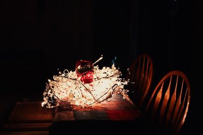 Close-up of illuminated lighting equipment in darkroom