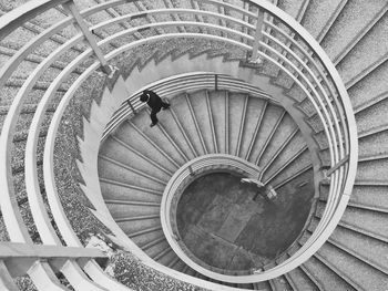 High angle view of man walking on spiral staircase