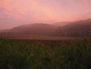 Scenic view of field against sky during sunset