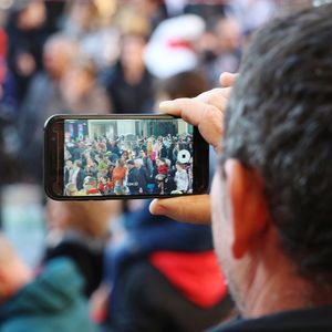 Rear view of man photographing