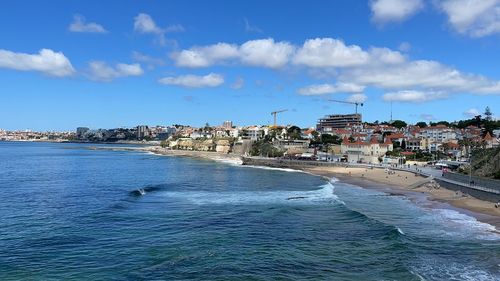 Panoramic view of beach and buildings against sky