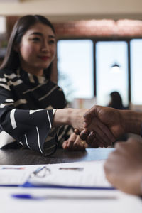 Business colleagues shaking hands in office