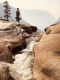 Rocks in sea against sky