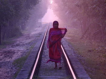  woman standing on railroad track