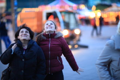 People on city street during winter at night