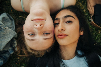 Teenage girls lying together at park