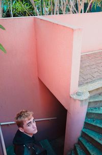 Portrait of man by wall