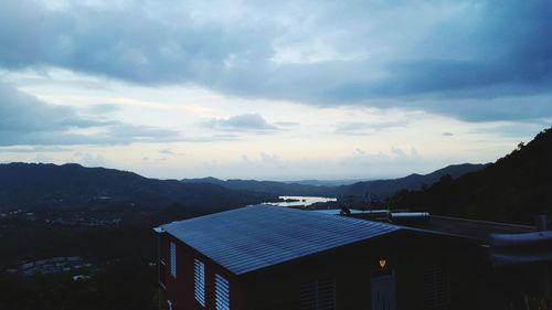 Scenic view of buildings and mountains against sky