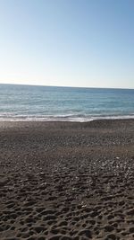 Scenic view of beach against clear sky