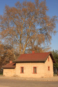 House and trees against sky during autumn