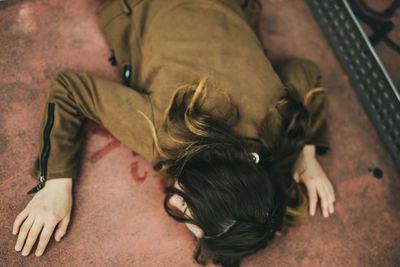 High angle view of woman lying on floor
