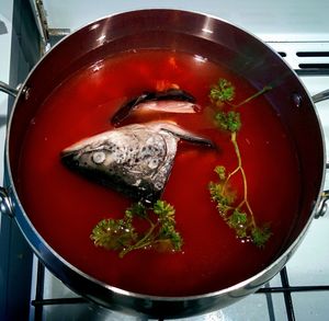 Close up of fish head soup on stove