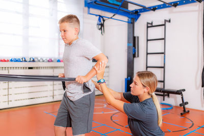 Shoulders and back exercise for children with resistance bands