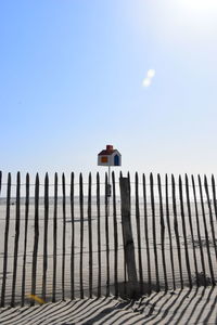 Low angle view of fence against clear sky