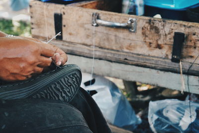 Cropped image of man repairing shoe