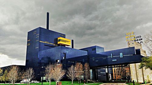 Low angle view of building against cloudy sky