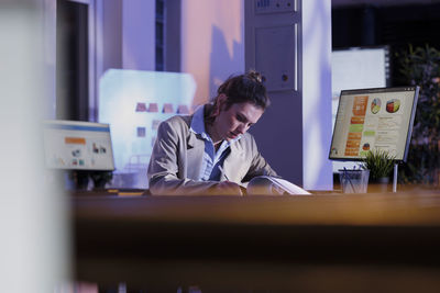 Young woman using mobile phone in cafe