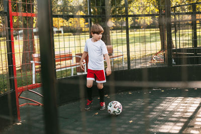 Full length of boy playing soccer