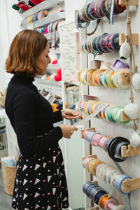 Side view of a woman standing in store