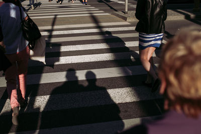 High angle view of people crossing road in city