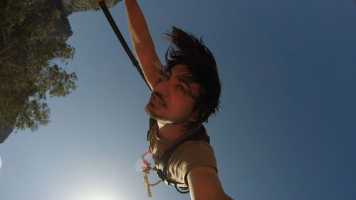 Low angle view of woman against clear sky