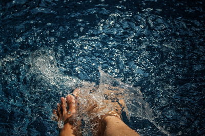 Low section of woman legs in water