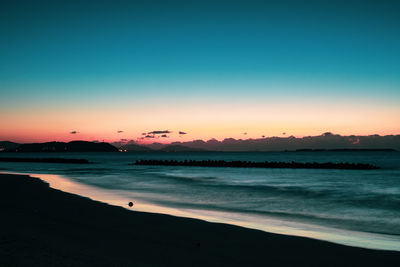 Scenic view of sea against clear sky during sunset