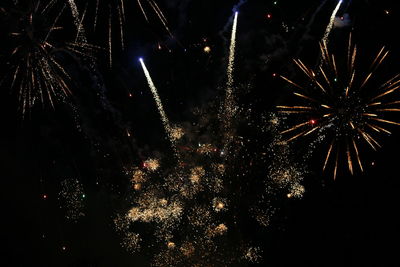Low angle view of firework display at night