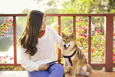 Woman with dog sitting outdoors