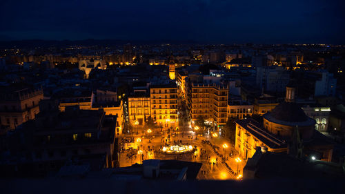 High angle view of illuminated buildings in city at night