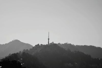 Low angle view of communications tower against sky