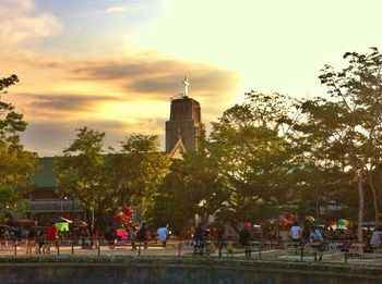 Silhouette of people against cloudy sky