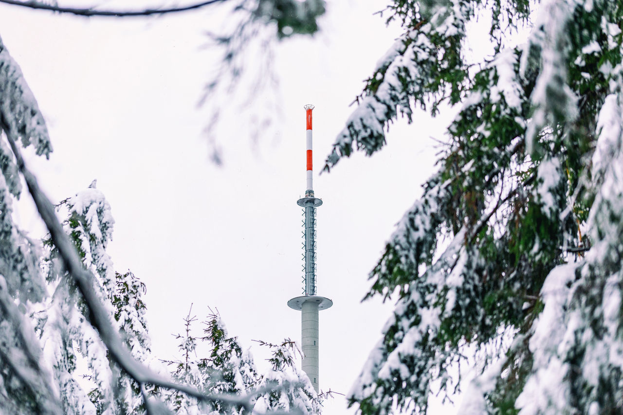 LOW ANGLE VIEW OF COMMUNICATIONS TOWER DURING WINTER