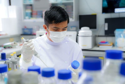Side view of female scientist holding dentures