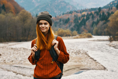 Portrait of smiling young woman standing outdoors