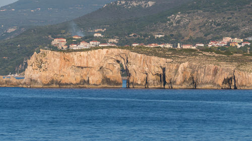 Scenic view of sea by mountains