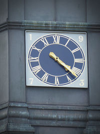 Low angle view of clock on wall