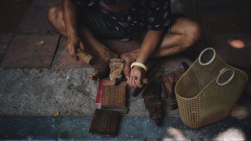 Low section of man making sculptures