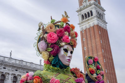 Low angle view of statue of pink flowers