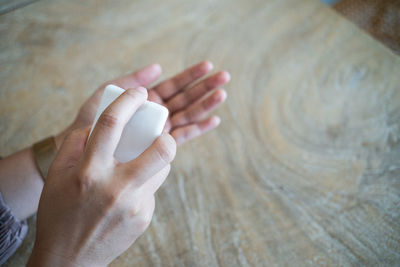 High angle view of person hand holding wood