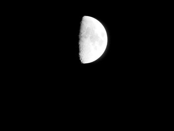 Low angle view of moon against dark sky