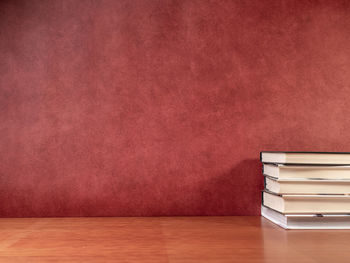 Stack of books on table against wall