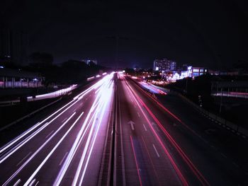 High angle view of light trails on highway at night
