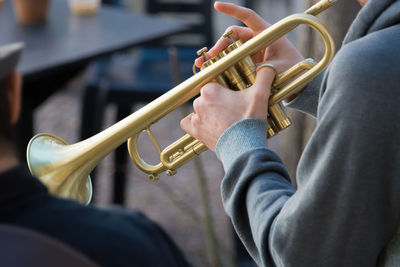 Close-up of person holding musical instrument