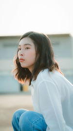 Portrait of young woman looking down