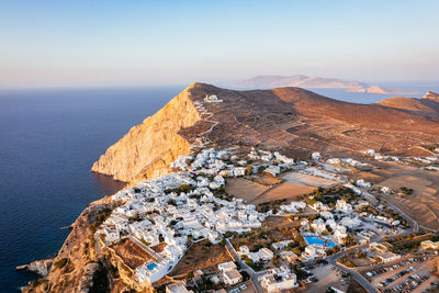 High angle view of townscape by sea against sky