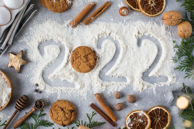 Christmas card with spices biscuits and number of next year written with flour